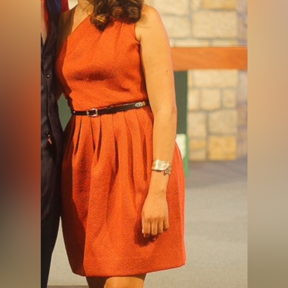 One shoulder orange dress.